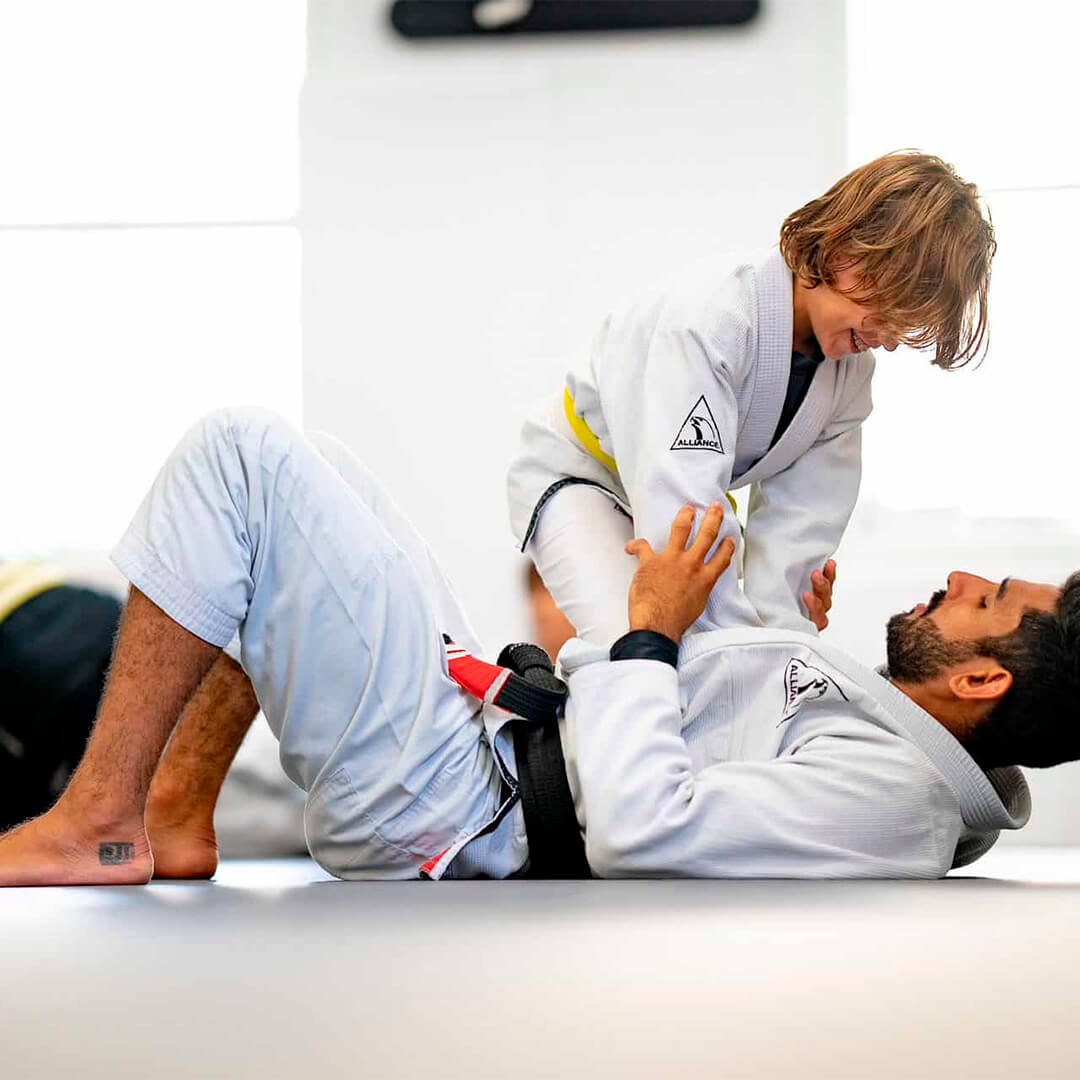 Instructor teaching a technique to young students