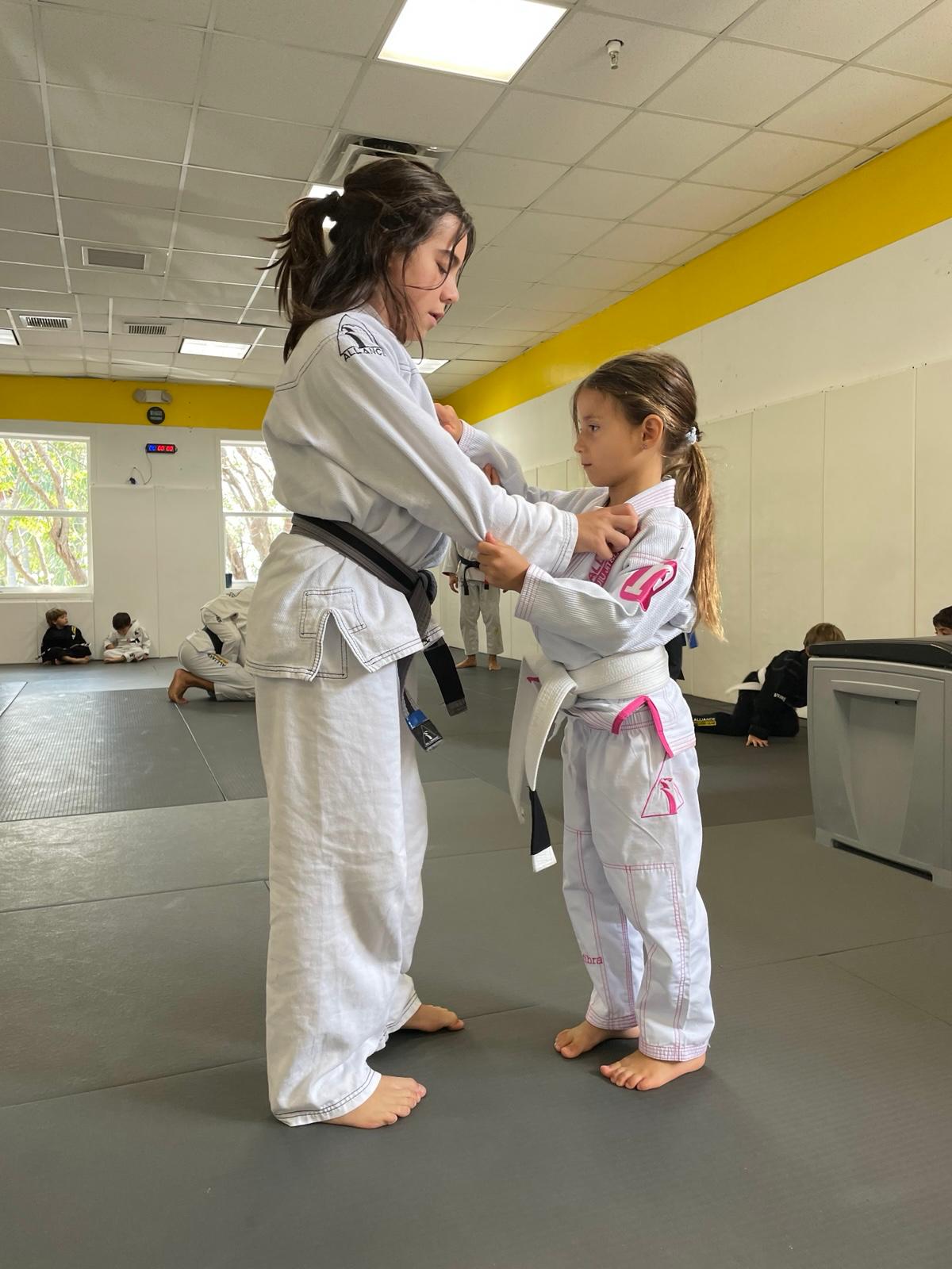 Instructor teaching grips to a young student