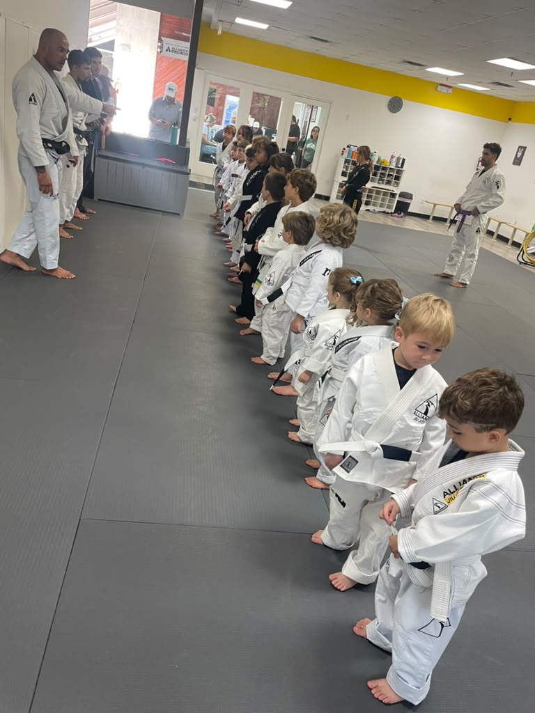 Kids Jiu-Jitsu students lined up in their gis with their instructors at Alliance Key Biscayne
