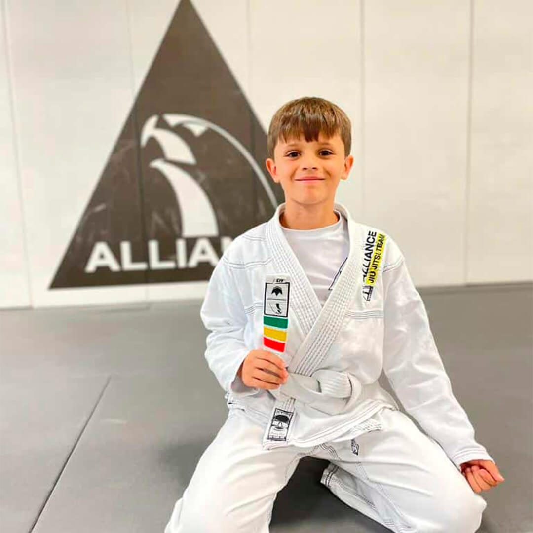 Young Alliance student with his colored-stripe belt