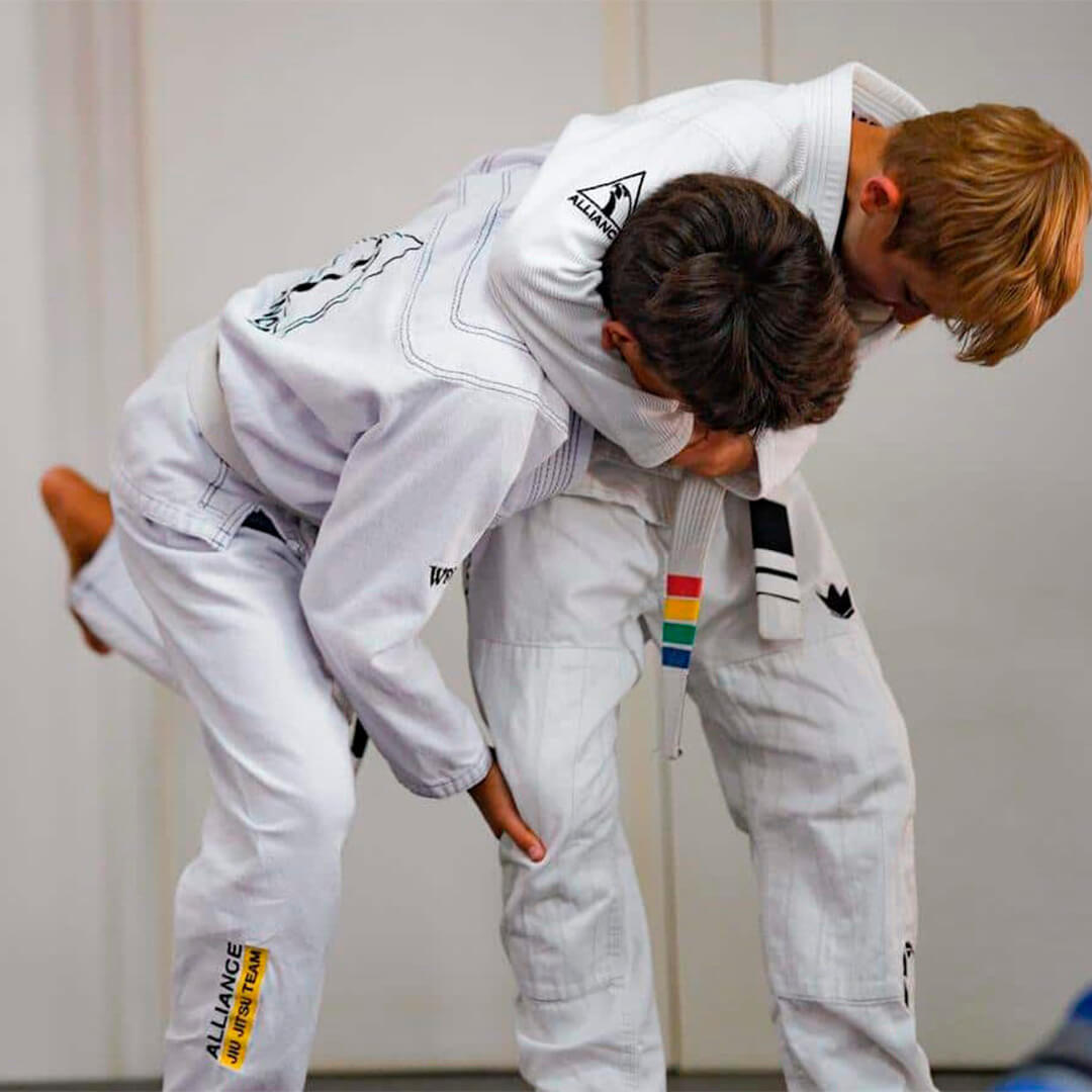 Students drilling a takedown during class